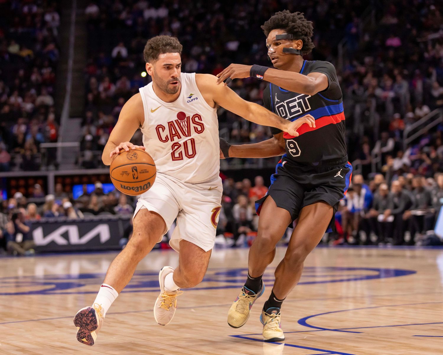 Dec 2, 2023; Detroit, Michigan, USA; Cleveland Cavaliers forward Georges Niang (20) moves the ball up court as Detroit Pistons forward Ausar Thompson (9) defends during the first half at Little Caesars Arena.